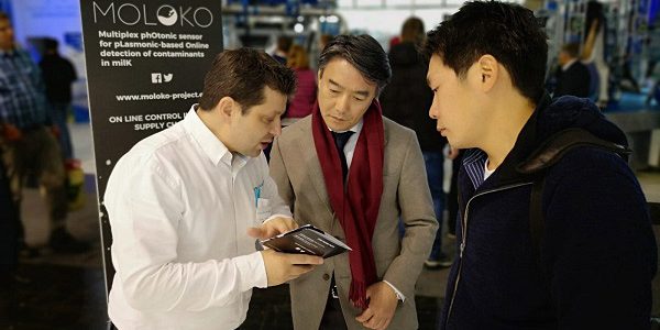 Milkline-partner-shows-MOLOKO-project-brochure-to-some-fair-visitors